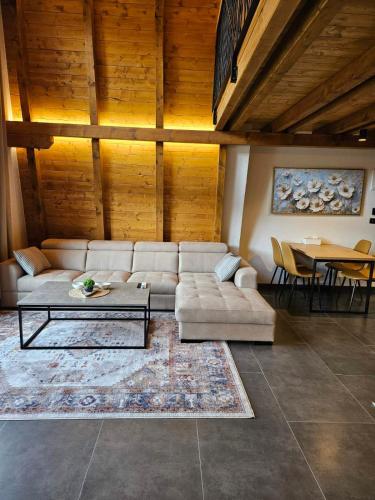 a living room with a couch and a table at Luxury Villa Mašić -Apartment Ali in Bugojno
