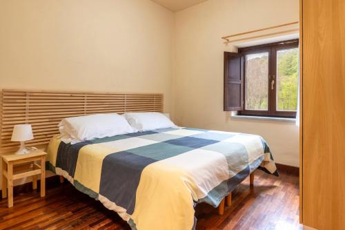 a bedroom with a large bed and a window at Rifugio Giuliano Marini in Piano Battaglia