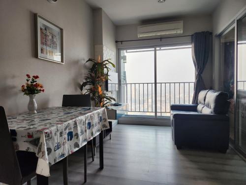 a living room with a table and a balcony at centric sea pattaya中心海 in Pattaya