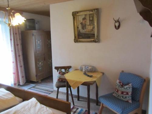a living room with a table and two chairs at Haus Annelies Walchsee in Walchsee