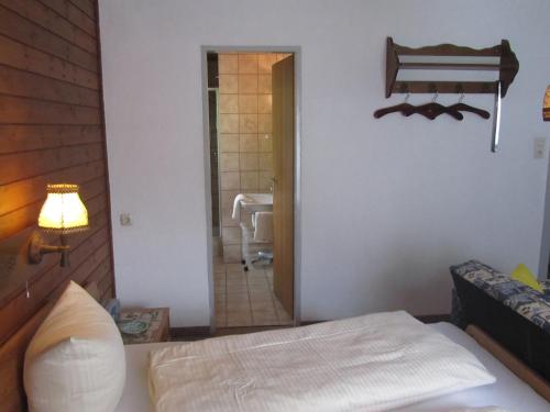 a bedroom with a bed and a bathroom with a tub at Haus Annelies Walchsee in Walchsee