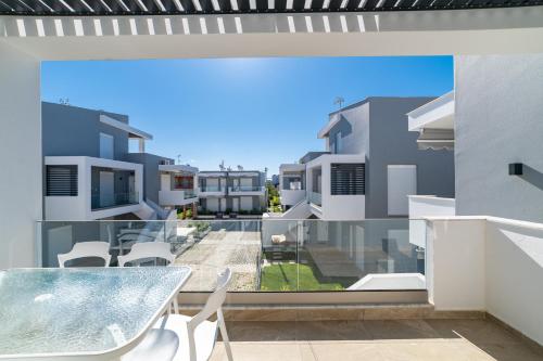a view from the balcony of a apartment with a table and chairs at Roxani Residential Complex in Ofrínion