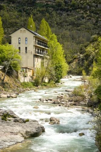 a building on the side of a river at Hotel Casa Peix in Serraduy