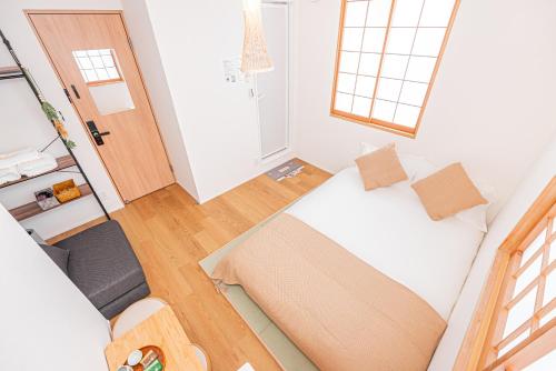 a small room with a bed and a chair at Kamakura no Nikki in Kamakura