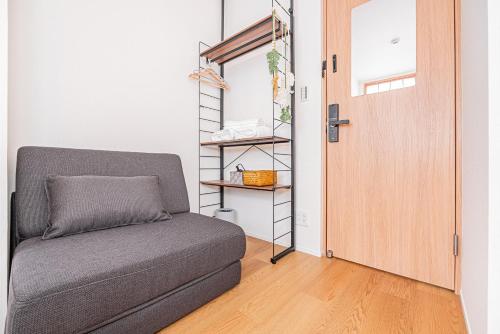 a room with a couch next to a door at Kamakura no Nikki in Kamakura