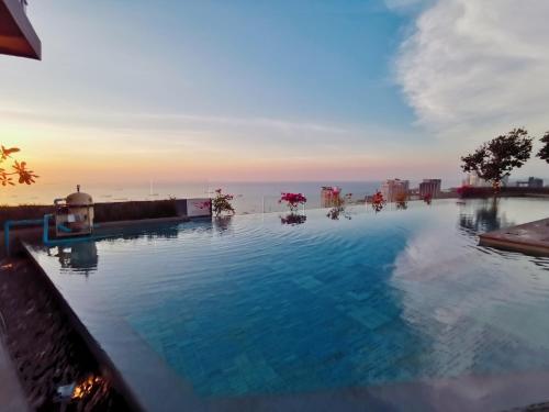 a swimming pool with a view of the ocean at centric sea pattaya中心海 in Pattaya