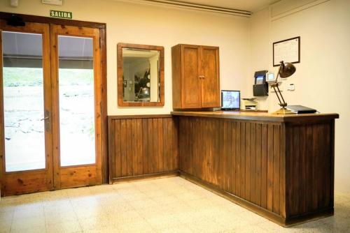 an office with a wooden counter and a mirror at Hotel Casa Peix in Serraduy