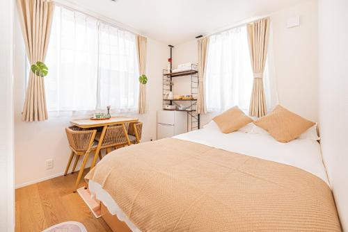 Postel nebo postele na pokoji v ubytování Kamakura no Nikki