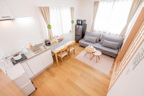 a kitchen and living room with a couch and a table at Kamakura no Nikki in Kamakura