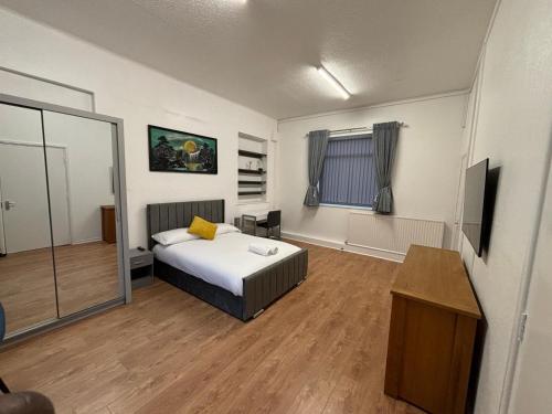 a bedroom with a bed and a television in it at Del Apartments in Warrington