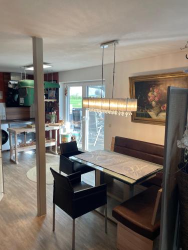 a dining room with a table and a couch at Luckylake in Muhr amSee