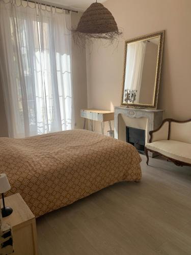 une chambre avec un lit, un miroir et une chaise dans l'établissement Port de nice, à Nice