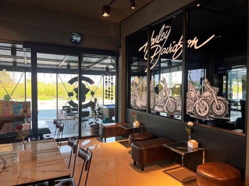 a restaurant with tables and chairs and motorcycles in the window at Dark Lights Retreat in Na Jomtien