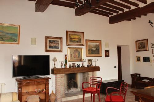 a living room with a tv and a fireplace at La Terrazza sull'Umbria in Collazzone