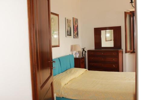 a bedroom with a bed and a dresser and a mirror at La Terrazza sull'Umbria in Collazzone
