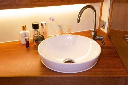 a sink with a toothbrush and other items on a counter at ''Alkyoni" Sailing Yacht in Thessaloniki
