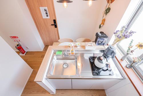 a small kitchen with a sink in a room at Kamakura no Nikki in Kamakura