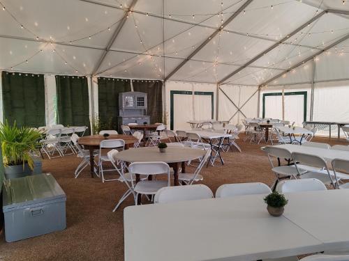a large tent with tables and chairs in it at Village Bord de Ciel in Caylus