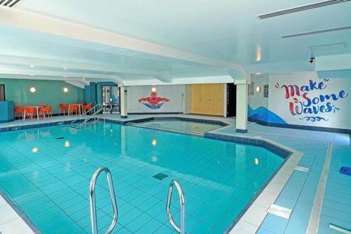 a large swimming pool in a hotel at Eagle's Den Caravan Holiday Retreat in Lossiemouth