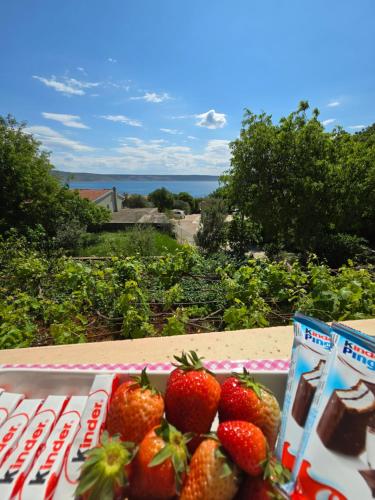 a plate of strawberries sitting on top of a table at Apartment Ante and Dijana in Starigrad-Paklenica