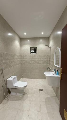 a bathroom with a toilet and a sink at شقة بأثاث فُندقي in Al Madinah