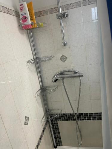 a shower with a glass door and a shower head at Maison bord de mer pour 2 à 6 pers in La Tranche-sur-Mer
