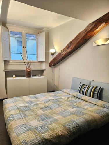a bedroom with a bed and a window at City Center Heart in Turin