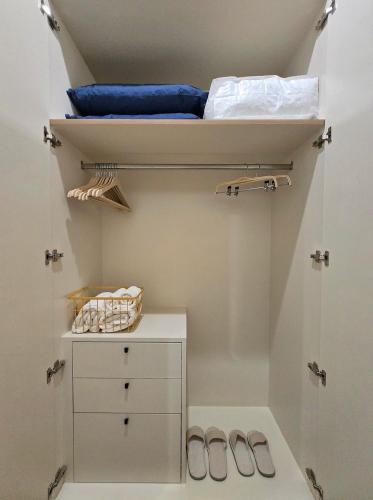a bedroom with a bunk bed and two shoes at Coastal getaway at Cha-am in Ban Bang Sai Yoi (1)