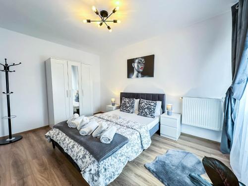 a bedroom with a bed and a ceiling fan at Sunrise Apartments City Center in Bucharest