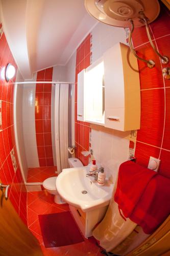 a bathroom with a white sink and a toilet at Piano apartments in Kotor