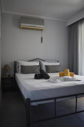 a bedroom with a large bed with white sheets at Fotini's studio in Paleo Tsifliki