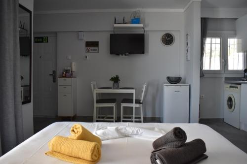 a bedroom with a bed with towels on it at Fotini's studio in Paleo Tsifliki