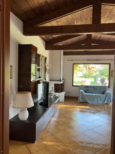 a living room with a tv and a couch at Green Cottage in Casal Palocco