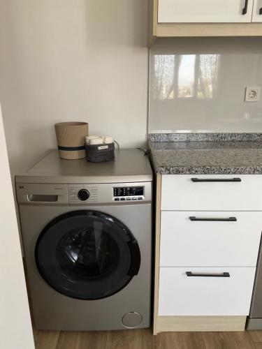 a kitchen with a washing machine and a counter at Dalaman Apart in Bezkesen