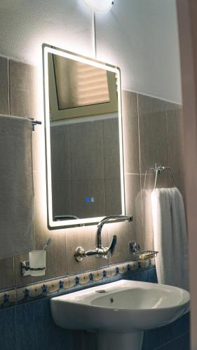 a bathroom with a sink and a mirror at Oaz Guest House Durres in Durrës