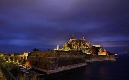 a small island in the water at night at Aristoula's view in Perlopsimades