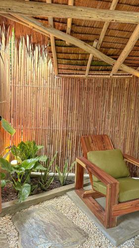 a room with a chair in a straw hut at Casa Kalikasan 2 in El Nido