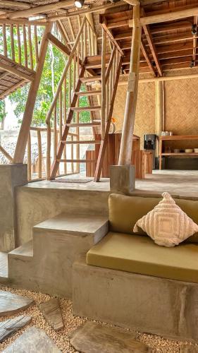 a room with stairs and a couch with a pillow at Casa Kalikasan 2 in El Nido