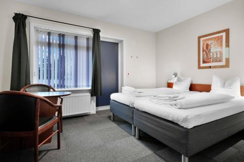 Postel nebo postele na pokoji v ubytování Hotel Varde