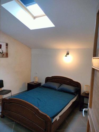 a bedroom with a large bed and a skylight at GitesLuberon 2 F2 in Charleval