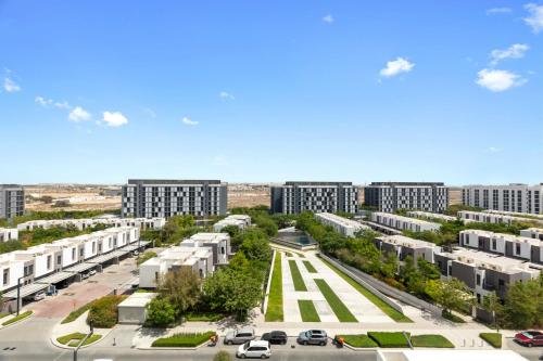 an aerial view of a city with tall buildings at Sahab - Misk 1BR Apt -High Floor in Sharjah