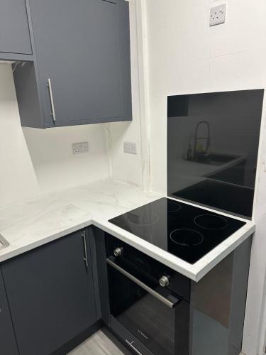 a kitchen with a stove and a counter top at Del Apartments in Warrington