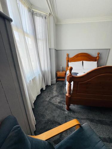 a bedroom with a wooden bed and a window at The Anchor in Trowbridge