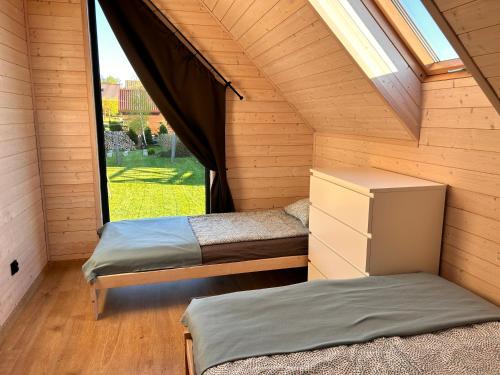 two beds in a room with a window at Norbea in Sasino