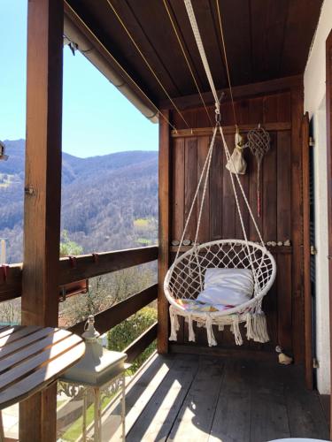 a swing on a porch with a view of the mountains at Casa dell'Arte in Lugano