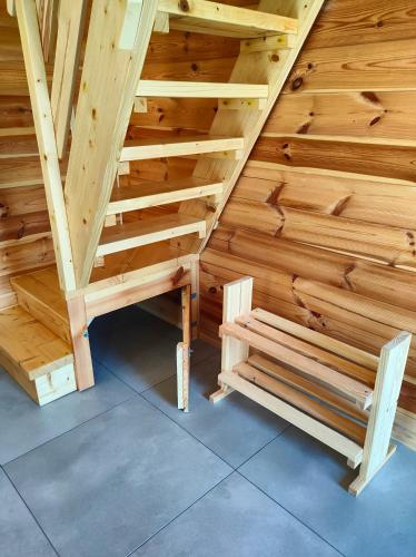 a wooden staircase in a room with wooden walls at Malinówka Kruczy Borek in Kruczy Borek