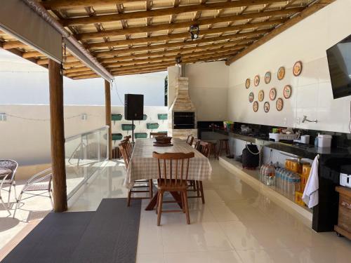 una cucina e una sala da pranzo con tavolo e sedie di Casa Top Vilas a Lauro de Freitas