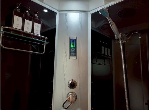 a bathroom with a shower with a toothbrush in it at Hotel EL Utsunomiya 7 free parking in Utsunomiya