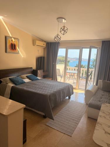 a bedroom with a bed and a couch and a balcony at Imperia in Bar