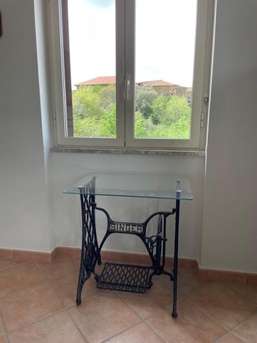 a glass table in a room with a window at Pink House in Perdifumo